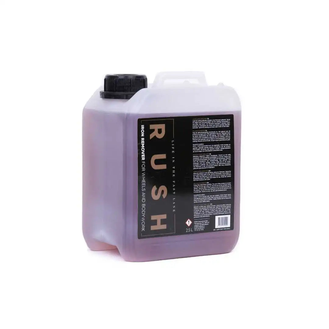 A 2.5-liter translucent plastic container with a black screw cap, filled with purple liquid and labeled "Iron Remover 2,5 liter" for wheels and bodywork, plus additional text.